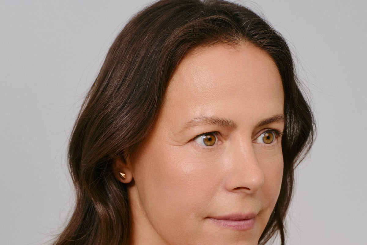 Close-up portrait of a woman in her 50s with natural, mature skin